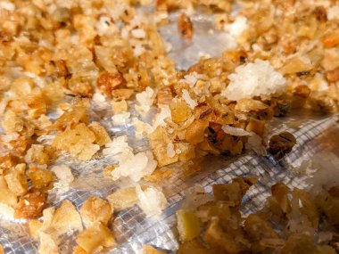 A Close up of nasi aking or aking rice. a food that comes from inedible leftover rice that is cleaned and dried in the hot sun.  Baking rice is usually sold as poultry food