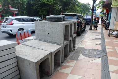 concrete u shape on the side of the road. surabaya, indonesia - 6 maret 2024 clipart