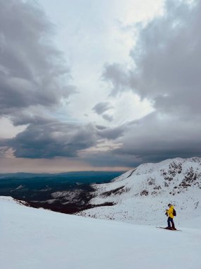 Bir kayakçı, Kasprowy Wierch zirvesinde dağların arka planına doğru inişe hazırlanıyor. Yüksek kalite fotoğraf