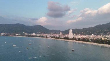 Patong Sahili 'nde hayat tam gaz devam ediyor. Etrafı tepelerle çevrili oteller ve turistlerle dolu bir tatil yeri. Phuket Adası, Tayland