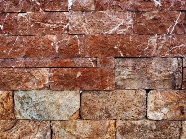 Textura de piedra roja en ladrillo de muro en Las Palmas de Gran Canaria. Espana 2023