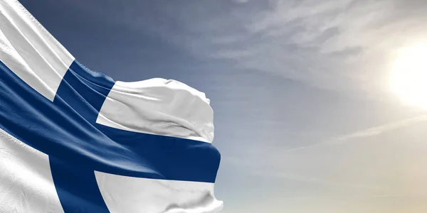 stock image Finland national flag cloth fabric waving on beautiful grey sky Background.