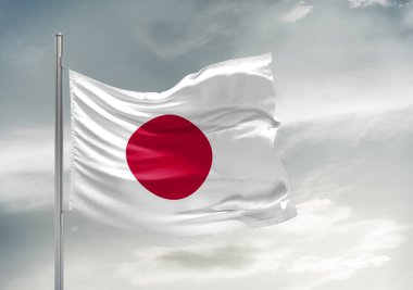 Japonya ulusal bayrak kumaşı güzel gri arka planda dalgalanıyor.