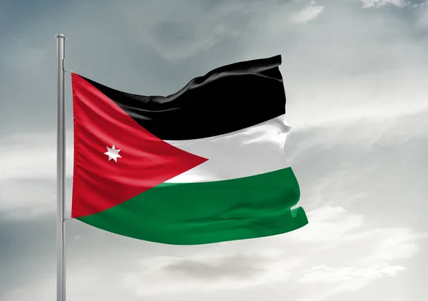 美しい灰色の空に手を振ってヨルダン国旗布背景 — ストック写真