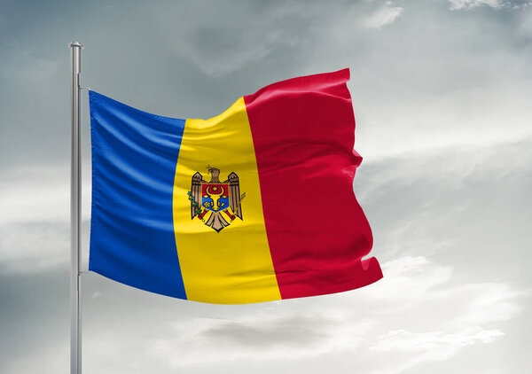 Moldova national flag cloth fabric waving on beautiful grey sky Background.