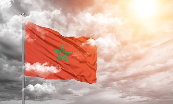 stock image Morocco national flag cloth fabric waving on beautiful cloudly grey Background.