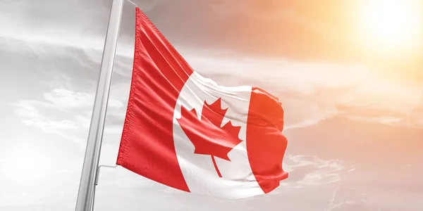 stock image Canada national flag cloth fabric waving on beautiful Cloudy Background.