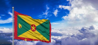Grenada Ulusal Bayrak Kumaşı Güzel bulut Arka planında dalgalanan.