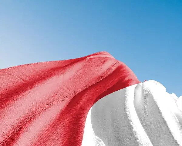 stock image Monaco national flag cloth fabric waving on beautiful sky blue Background.