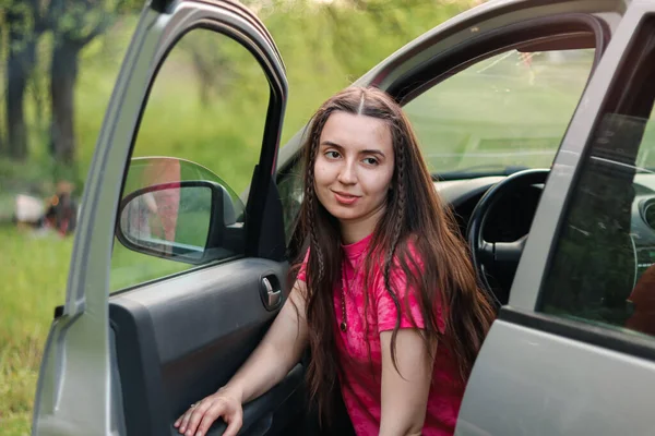 Rent a auto.car rental.Woman driver.Driving school.Auto enthusiast.Traveling by car.Driver.Auto in nature.Girl sitting in the car.Beautiful woman sitting in the car.Automotive.outdoor portrait.happy.buying a new car.feminism.certainty.Self-sufficient