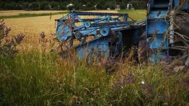 old harvester in the field.agribusiness.retro machinery.harvesting.wheat harvesting.agronomist.tractor in the field.cobine work in the field.Ukrainian field. harvest in the field