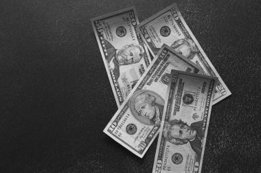 ABD dolarları tahtadan arka planda. Siyah bir arkaplanda dolar banknotları. Uluslararası para birimi.dolar döviz borsası.varlık.wal.y.country economy.desktop duvar kağıdı. Masada para. Bir sürü banknot. Banka kredisi. Siyah ve beyaz bankacılık sistemi..