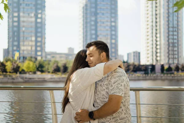 Romantic date.Man and woman.Love of two people.Real relationship.Happy family.Real couple of lovers.couple hugs.Photo for valentine's day.Valentine's day.couple on the background of tall buildings.buying an apartment.people in city backdrop of houses