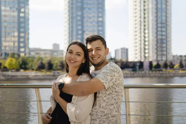 Romantic date.Man and woman.Love of two people.Real relationship.Happy family.Real couple of lovers.couple hugs.Photo for valentine\'s day.Valentine\'s day.couple on the background of tall buildings.buying an apartment.people in city backdrop of houses