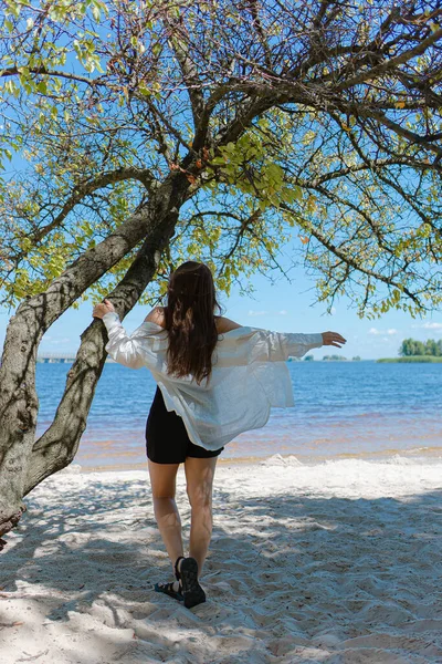 beautiful self-confident woman. joyful and inspired.feels freedom.Loneliness,thoughts and dreams.hair care.confidence.woman dreams.dreamer.emotion of inspiration.girl standing on the shore of a pond