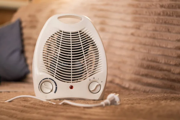electric fan on the table.Heat in the house.Turn off the heat in the house.Heater.Fan heater.Power outage.Cold in the apartment.Plastic heater.Cold winter.home heating. electrical problems.portable heater.dry air.floor fan