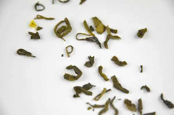 Beyaz zemin üzerinde küçük yapraklar (yapraklar) yeşil çay, yakın makro, kenar görünüm