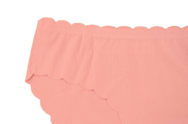 Peach pink seamless (invisible) women's underwear (lingerie, panties, briefs) with wavy edge isolated closeup clipart
