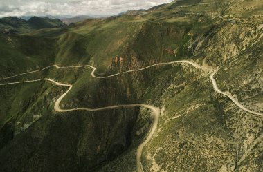 Cuesta del Obispo, Salta, Arjantin 'deki kavisli yolların hava manzarası. Nakliye aracı. Dağ uçurumundaki aşırı rota. Dağda yeşil otlarla kaplı tehlikeli yüksek yol. 