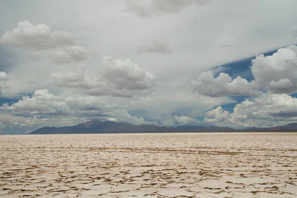 stock image White desert. View of the salt flats and mountains under a beautiful sky.