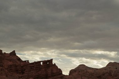 Jeoloji. Idyllic manzara. Güzel bir günbatımı gökyüzünün altında kırmızı kumtaşı ve kayalık dağlar görünüyor.. 