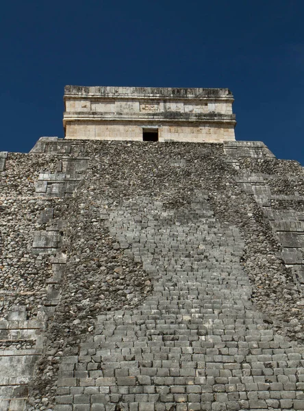 Travel. Ancient Maya civilization and architecture. Closeup of the apex of the mayan stone pyramid temple Kukulkan of Chichen Itza ruins in Yucatan, Mexico.