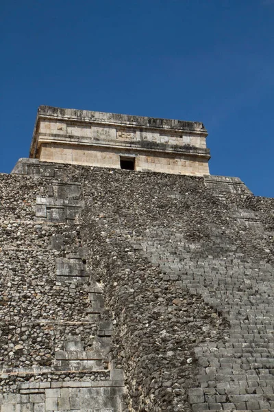 Travel. Ancient Maya civilization and architecture. Closeup of the apex of the mayan stone pyramid temple Kukulkan of Chichen Itza ruins in Yucatan, Mexico.