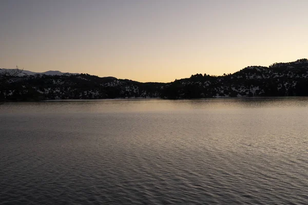 stock image Magical view of the calm lake and mountains at sunset. Beautiful dusk colors in the landscape.