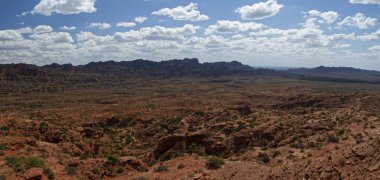 Seyahat et. Çöl manzarası. Kızıl çöl manzarası, kumtaşı, uçurumlar ve mavi gökyüzünün altındaki kayalık dağlar.