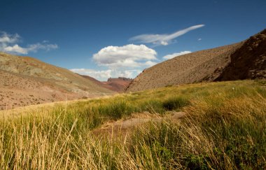 Bukolik manzara. Kırsal alan. Çayırların, vadilerin ve dağların Idyllic manzarası bulutlu güzel mavi gökyüzünün altında. 