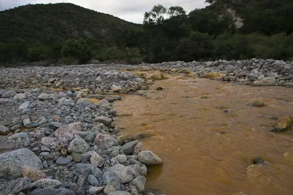 Unique yellow river called River of Gold due to the presence of iron, flowing along the rocky valley.
