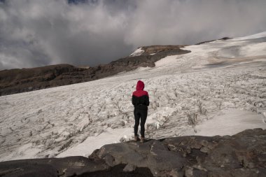 Arjantin 'in Tronador Tepesi zirvesinde, Glacier Castano Overo buz sahası ve karını düşünen bir kadın yürüyüşçü silueti görülüyor.. 