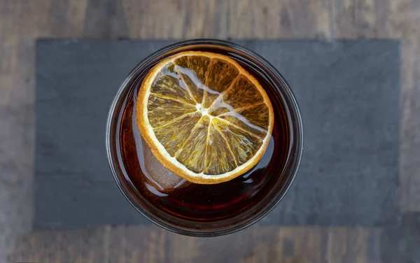 Cocktails. Top view of a Negroni alcoholic drink, with a dried orange slice.