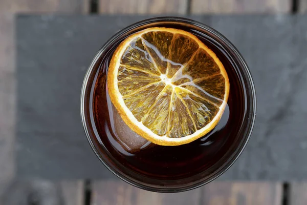 Cocktails. Top view of a Negroni alcoholic drink, with a dried orange slice.