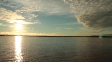 Traveling along the Parana river by boat. View of the river and horizon under a dramatic sunset sky