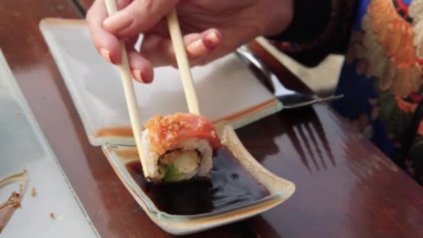 Female Hand Dips Sushi Roll Soy Sauce — Stock Video