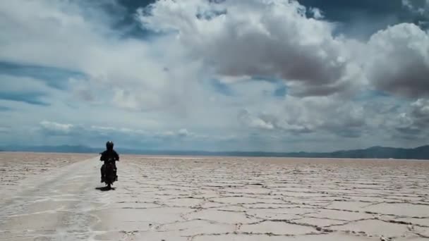 Man Motorcycle Traveling Salt Desert Majestic Sky — Stock Video