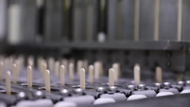 工业冰淇淋生产 工厂爆米花机 运输木棍并在冰棒模中放置木棍的自动化机器的截图 — 图库视频影像