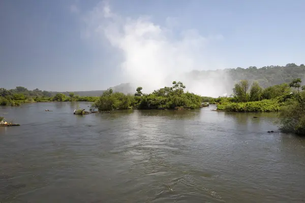 stock image The white mist and water splash created by the Iguazu falls in Garganta del Diablo, in Misiones, Argentina. The river flowing across the forest vegetation. 