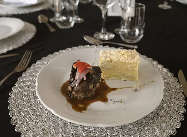 Sosyal bir etkinlikte gurme gastronomisi. Yakından bakınca soslu ızgara fileto ve galada beyaz bir tabakta patates mili feuille.