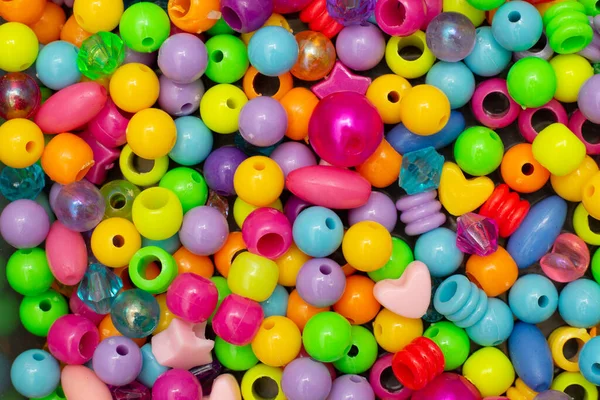 Colorful children\'s costume jewelry. Background of colored beads. Texture and macro image.