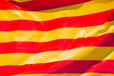 Katalonya bayrağının yakın çekimi, rüzgarda sallanıyor. Tüm çerçeveyi kaplayan Katalonya bayrağı.