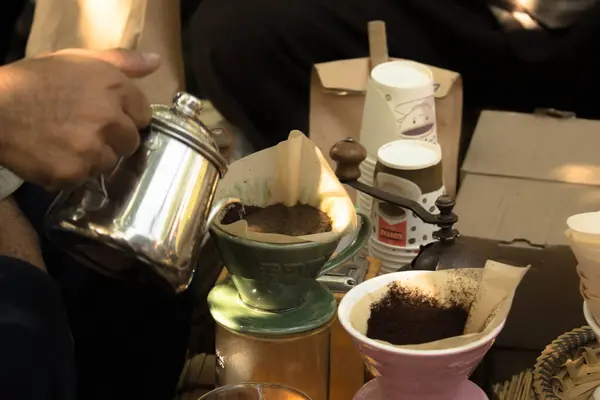 Hand drip coffee, Barista pouring water on coffee ground with filter.
