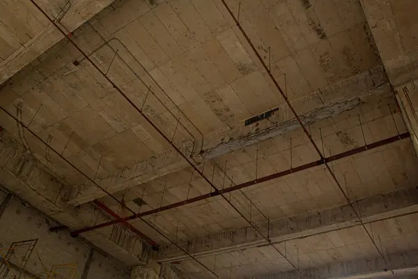 Construction of concrete floor under construction works. View from the bottom to the top