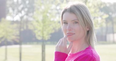Sensual portrait of pretty, strong and independent young woman with beautiful make-up and elegant hairstyle looking at the camera. Beauty, fashion and make up concept. High quality 4k footage