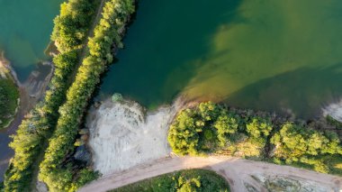 Aerial view drone shot of fresh green field in Spring near Turnhout by Antwerp, Belgium with road between fields. High quality photo