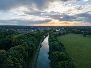 Summer dawn over foggy forest and river aerial drone view. Aerial panoramic landscape with sunset over the river and beautiful sky. High quality photo