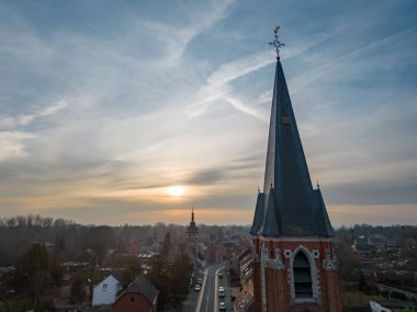 Emblem, Ranst, Belgium, 15th of February, 2023, Sint-Gummaruskerk, church of saint Gummarus, in the voortstraat of the Little village of Emblem, in the Antwerp area aerial photo during morning sunrise
