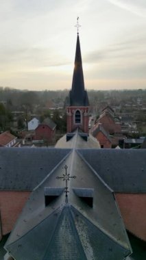 Emblem, Ranst, Belgium, 15th of February, 2023, Sint-Gummaruskerk, church of saint Gummarus, in the voortstraat of the Little village of Emblem, in the Antwerp area aerial photo during morning sunrise