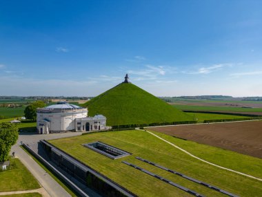 Aerial view farm field, Lions Mound, Battle field, Napoleon, Waterloo, Belgium, green and sky, season. Aerial View at the Waterloo Hill with the statue of the lion of Memorial Battle of Waterloo clipart